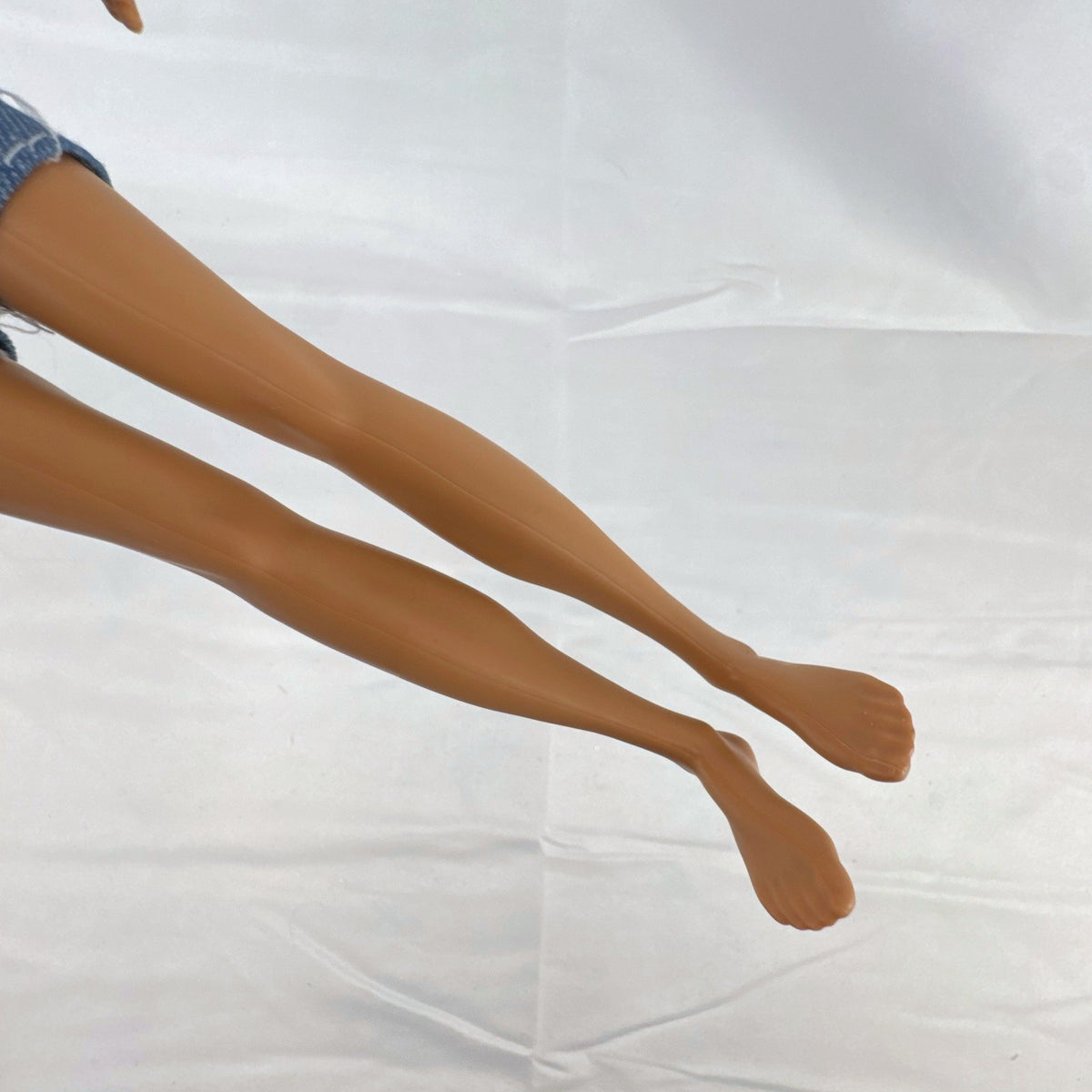Mattel Ken 12-inch slim fashion doll wearing a colorblock pocket t-shirt and denim shorts
