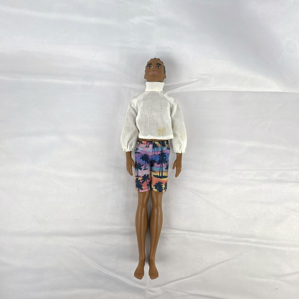 Mattel Barbie Fashionistas 12-inch Ken doll with molded cornrows wearing white mock neck top and palm tree shorts