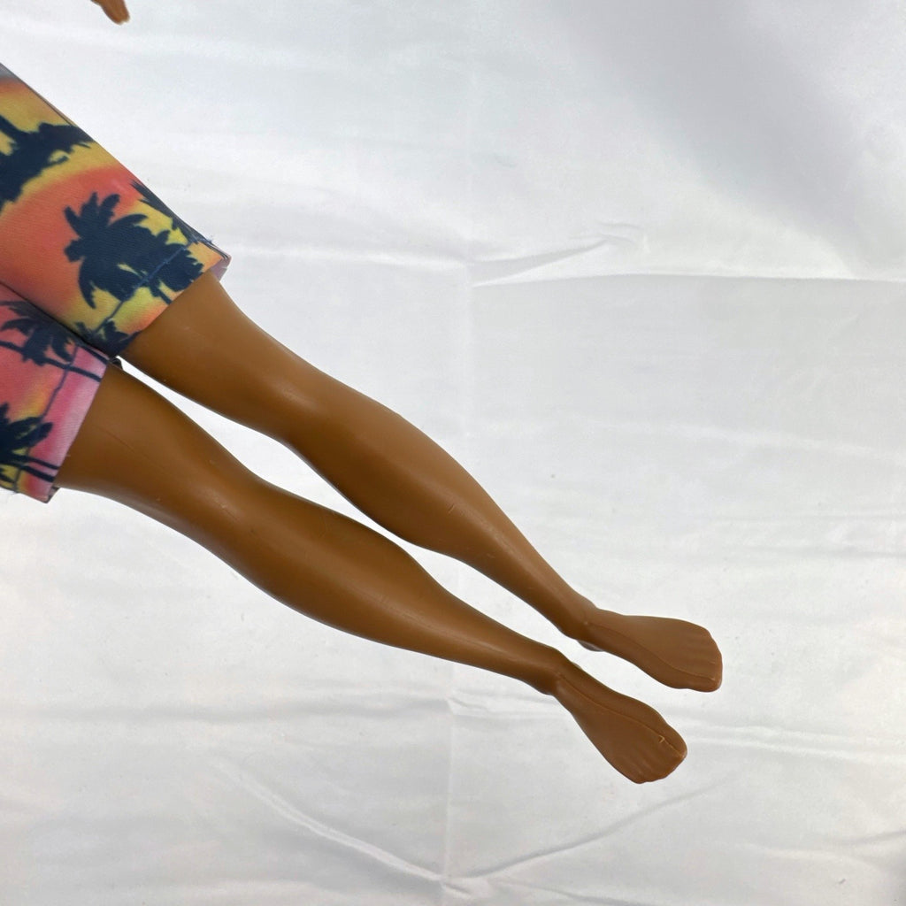 Mattel Barbie Fashionistas 12-inch Ken doll with molded cornrows wearing white mock neck top and palm tree shorts