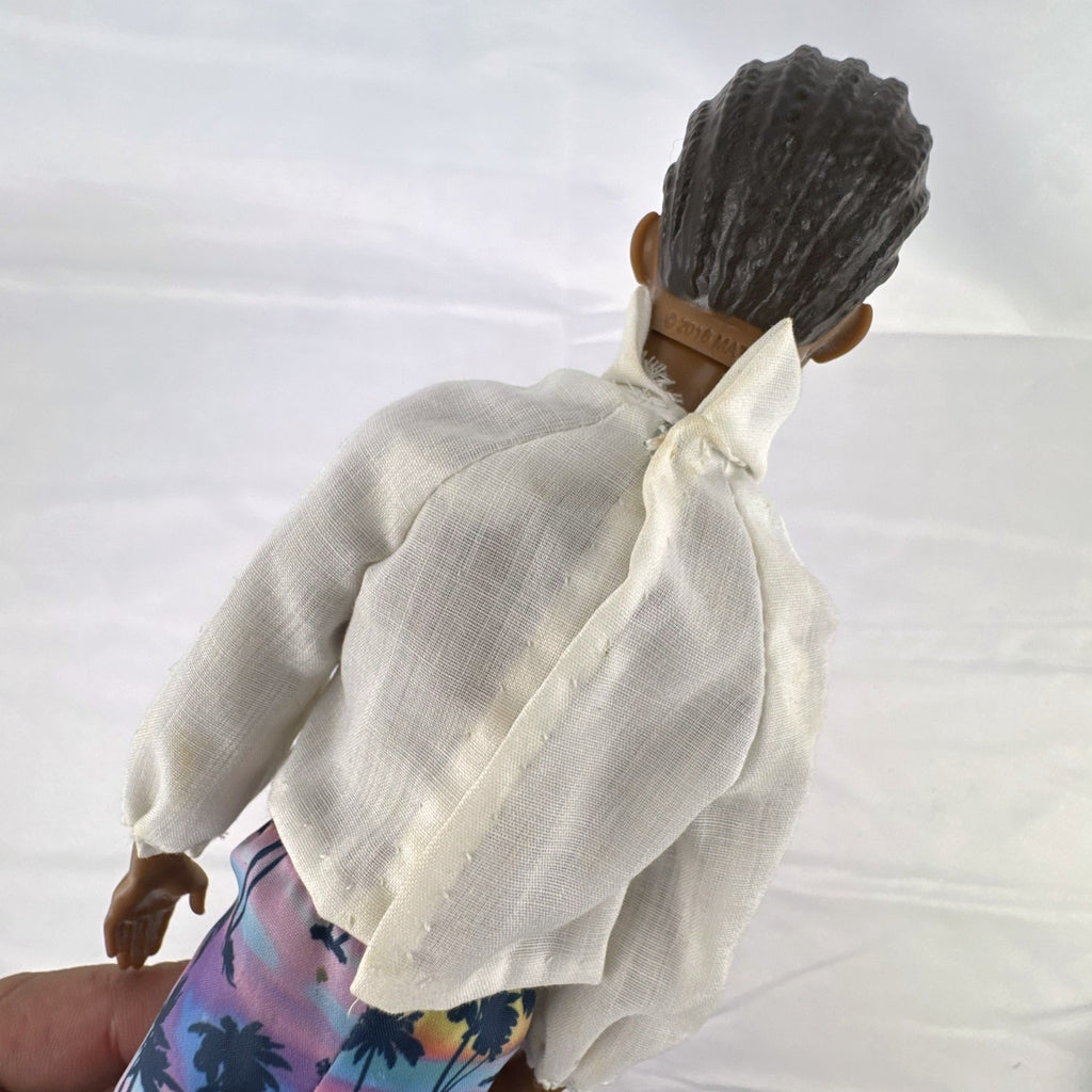 Mattel Barbie Fashionistas 12-inch Ken doll with molded cornrows wearing white mock neck top and palm tree shorts