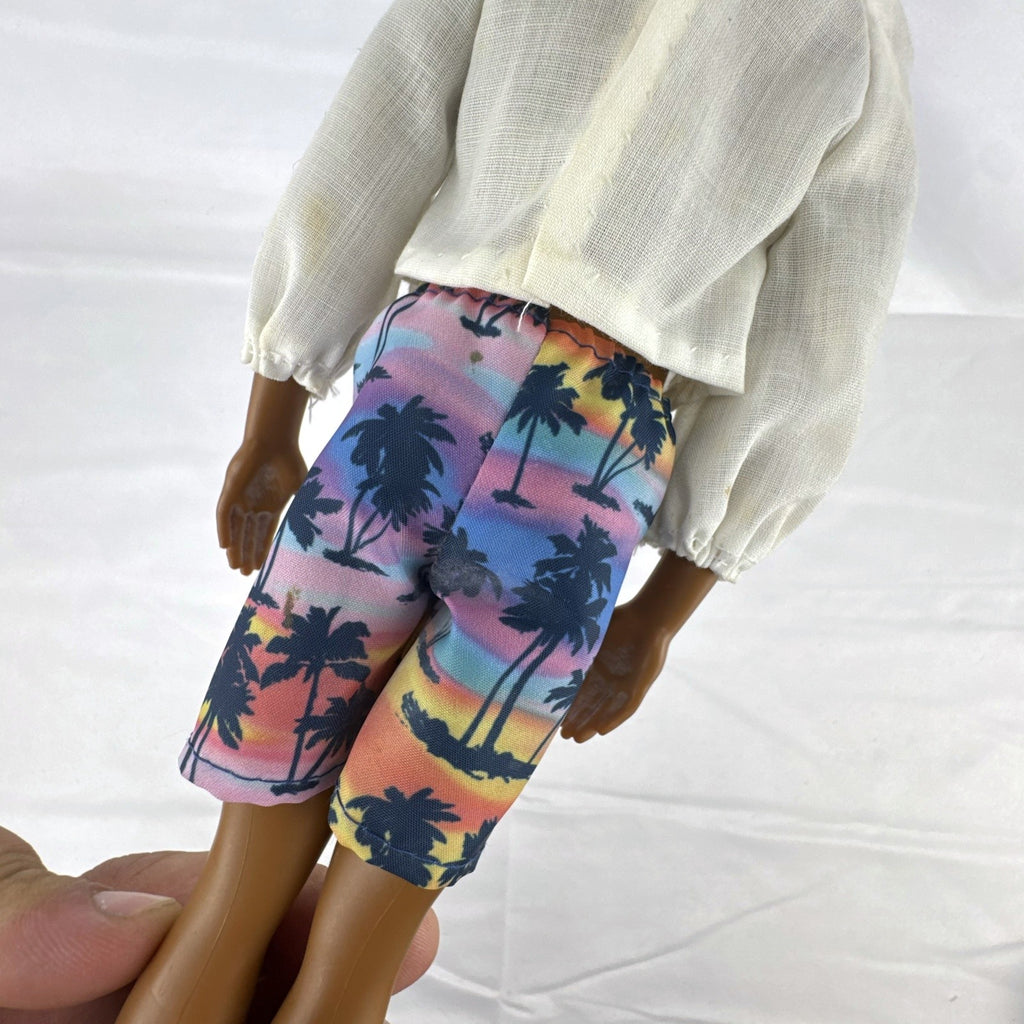 Mattel Barbie Fashionistas 12-inch Ken doll with molded cornrows wearing white mock neck top and palm tree shorts