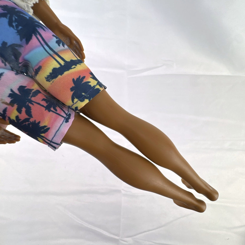 Mattel Barbie Fashionistas 12-inch Ken doll with molded cornrows wearing white mock neck top and palm tree shorts