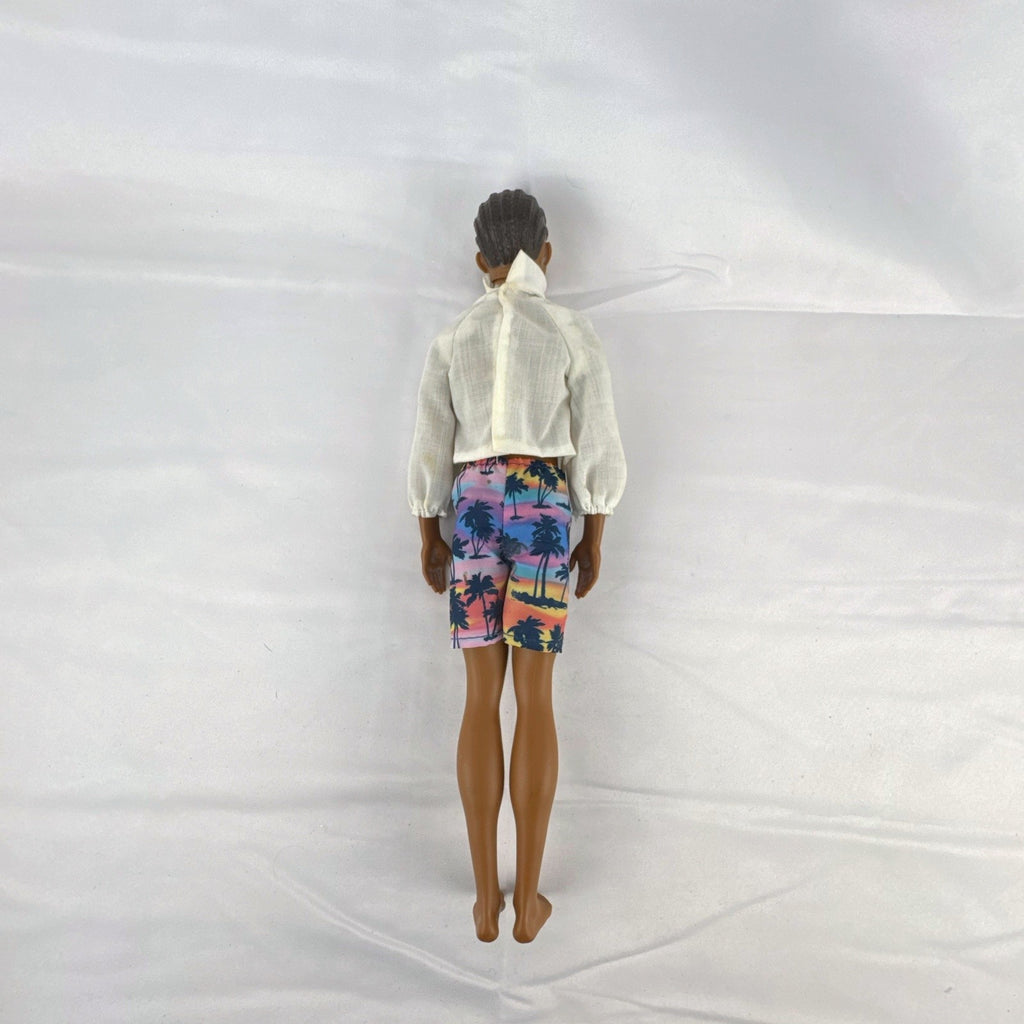 Mattel Barbie Fashionistas 12-inch Ken doll with molded cornrows wearing white mock neck top and palm tree shorts