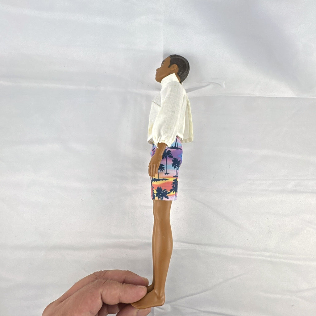 Mattel Barbie Fashionistas 12-inch Ken doll with molded cornrows wearing white mock neck top and palm tree shorts