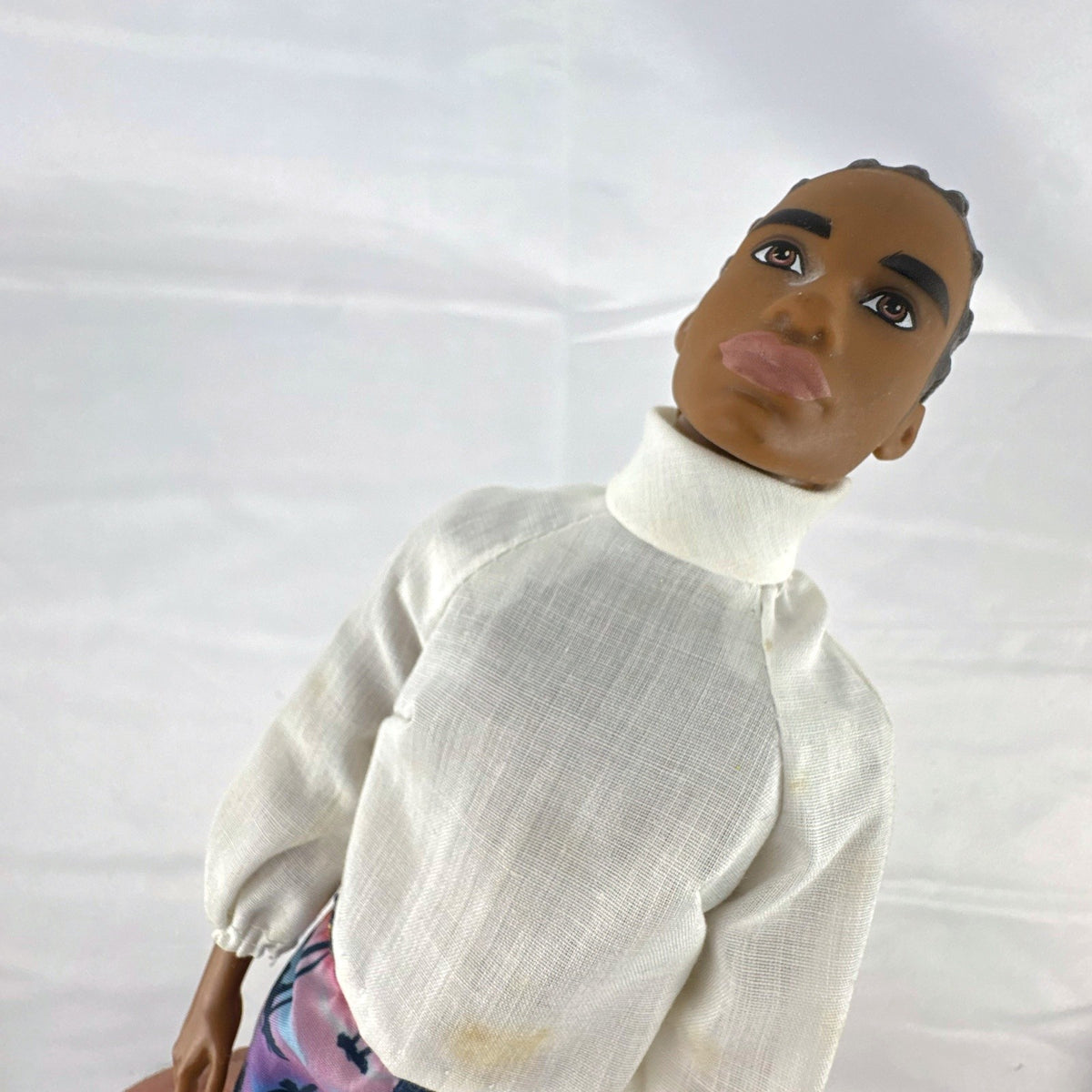 Mattel Barbie Fashionistas 12-inch Ken doll with molded cornrows wearing white mock neck top and palm tree shorts