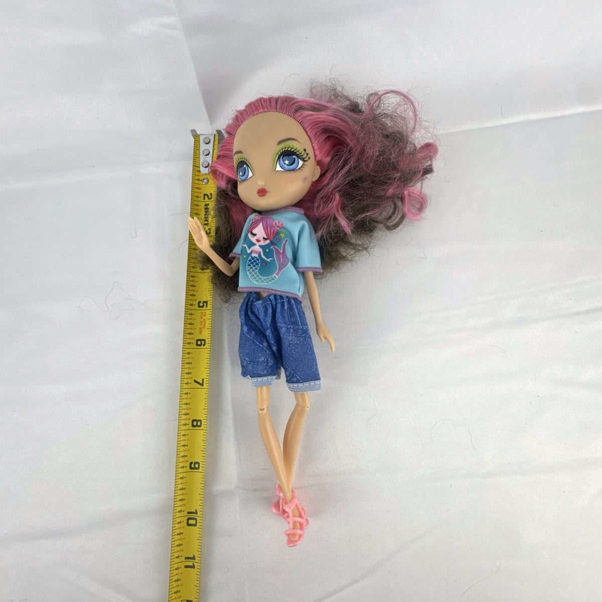 Spin Master La Dee Da Dee 10-inch fashion doll in blue mermaid outfit with brown and pink hair