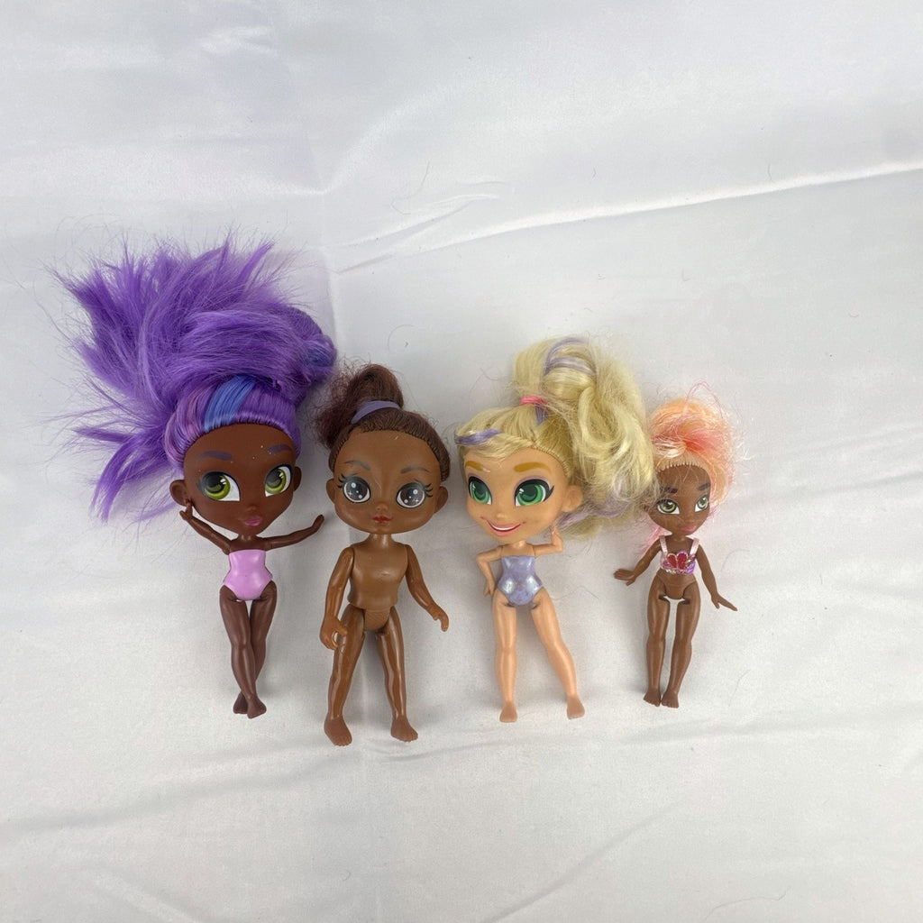 Four Just Play Hairdorables and Shortcuts mini fashion figures with colorful rooted hair