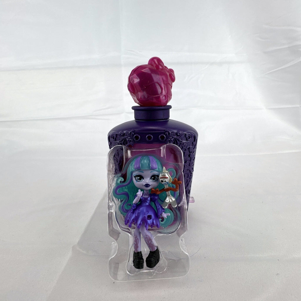 Mattel Monster High Potions Twyla mini figure inside purple potion bottle container with crystal skull topper