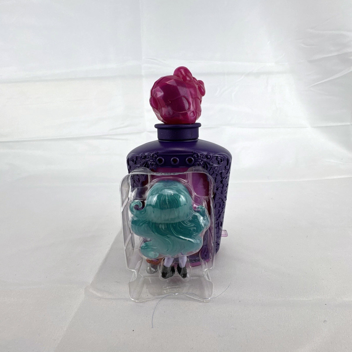 Mattel Monster High Potions Twyla mini figure inside purple potion bottle container with crystal skull topper
