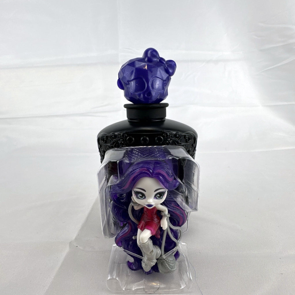 Mattel Monster High Spectra Vondergeist 3-inch mini doll inside a purple and black Skullette potion bottle display case.