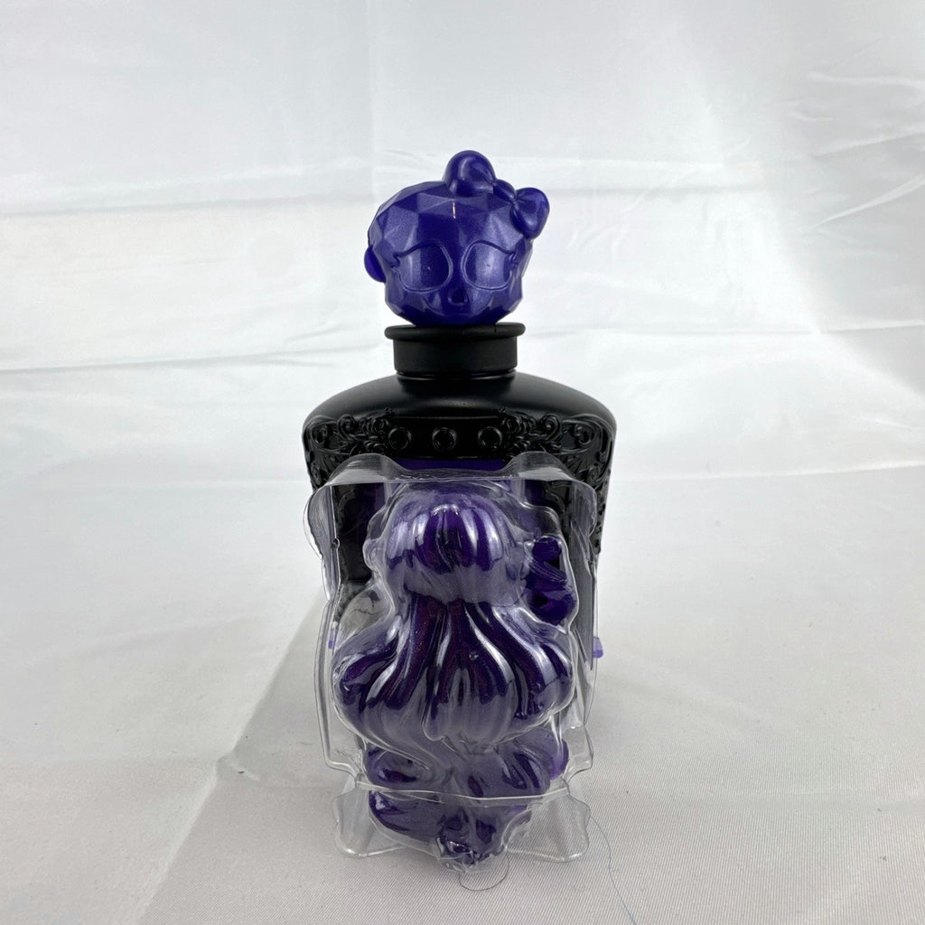Mattel Monster High Spectra Vondergeist 3-inch mini doll inside a purple and black Skullette potion bottle display case.