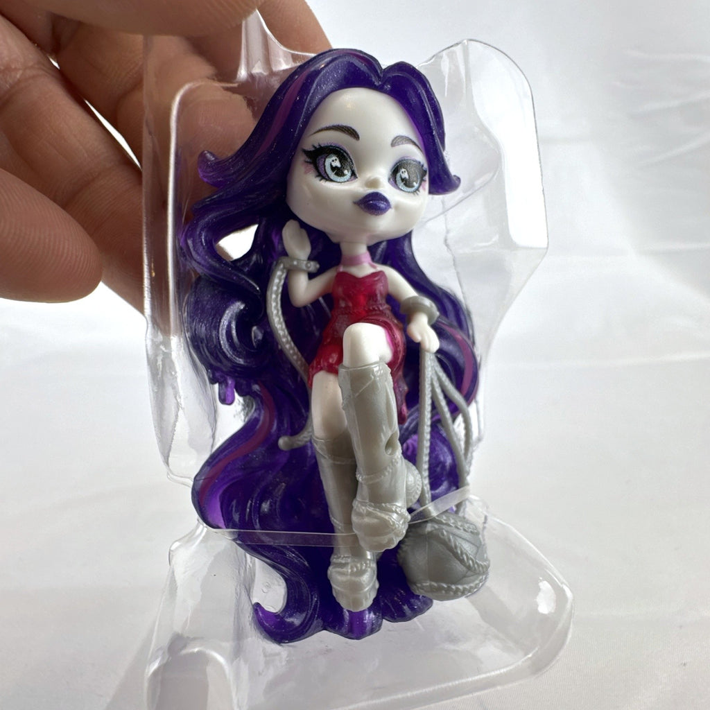 Mattel Monster High Spectra Vondergeist 3-inch mini doll inside a purple and black Skullette potion bottle display case.