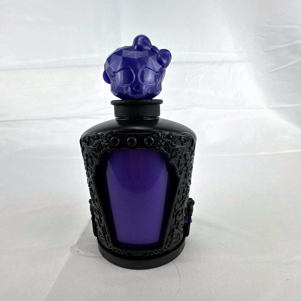 Mattel Monster High Spectra Vondergeist 3-inch mini doll inside a purple and black Skullette potion bottle display case.