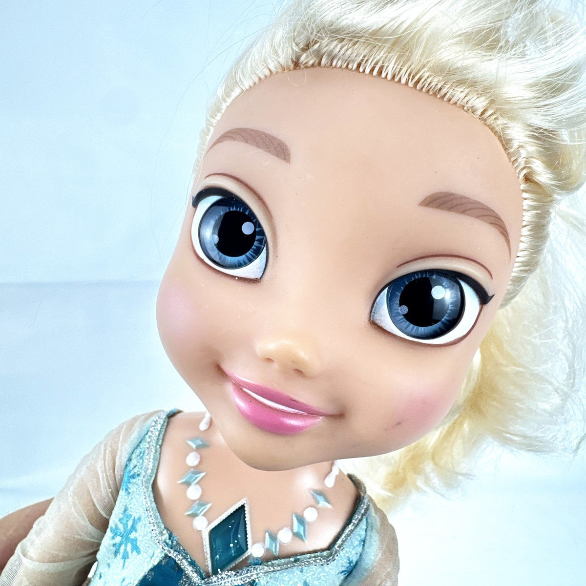 Jakks Pacific Disney Frozen Snow Glow Elsa 14-inch toddler doll wearing ice gown and glitter shoes