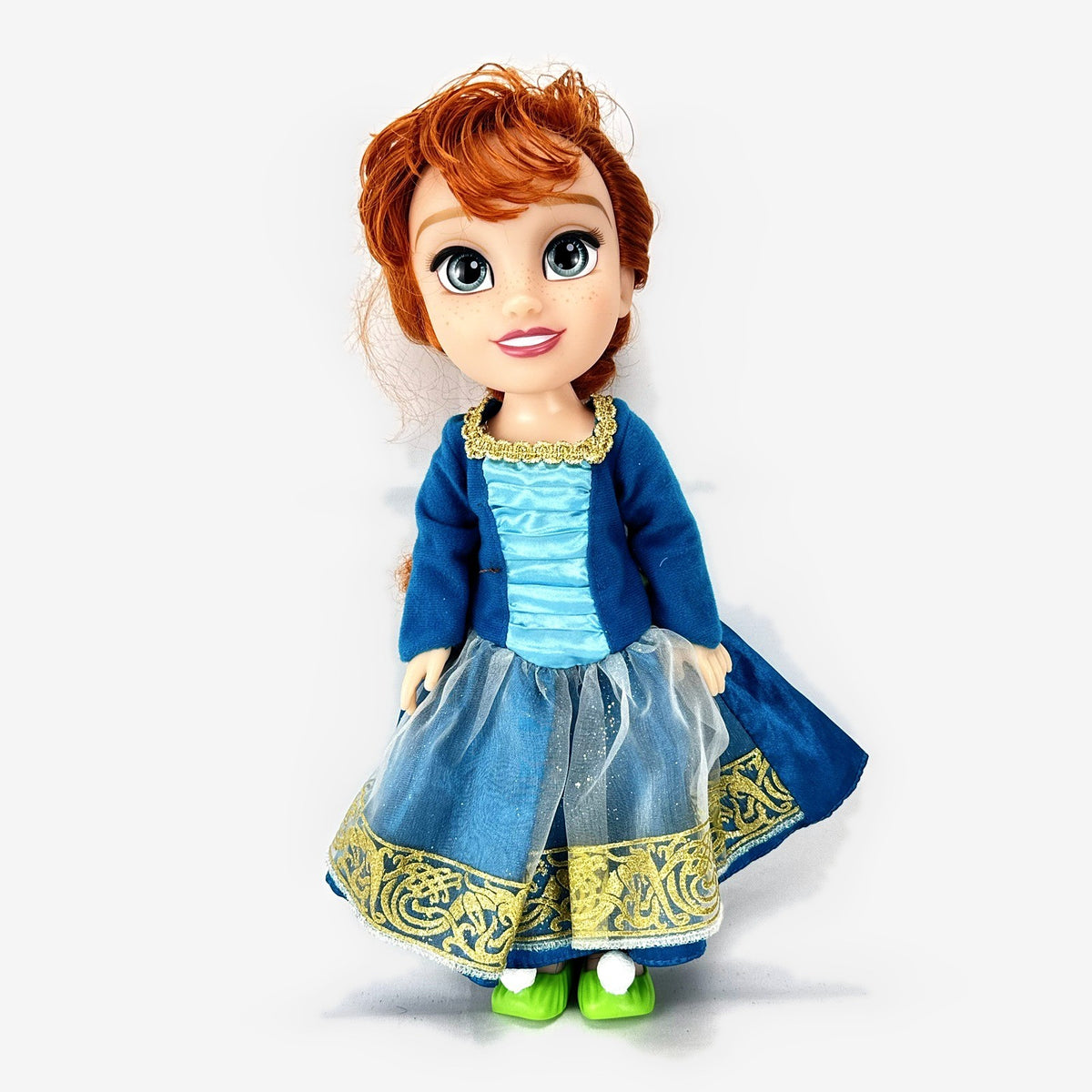Disney Frozen 13-inch toddler Anna doll wearing blue dress and green pom-pom shoes