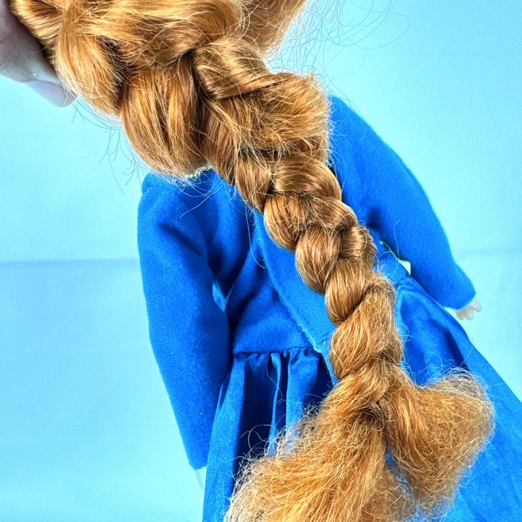Disney Frozen 13-inch toddler Anna doll wearing blue dress and green pom-pom shoes