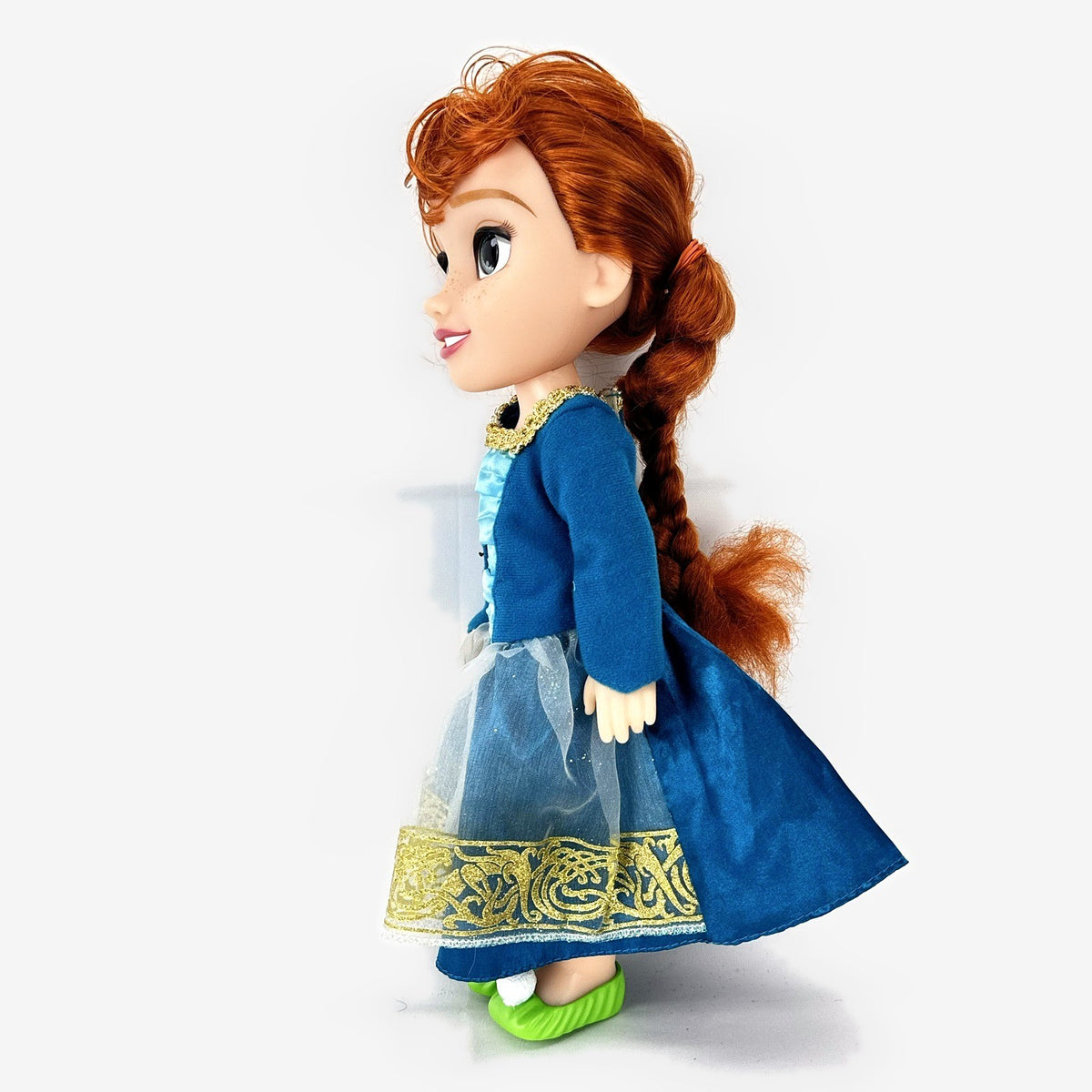 Disney Frozen 13-inch toddler Anna doll wearing blue dress and green pom-pom shoes