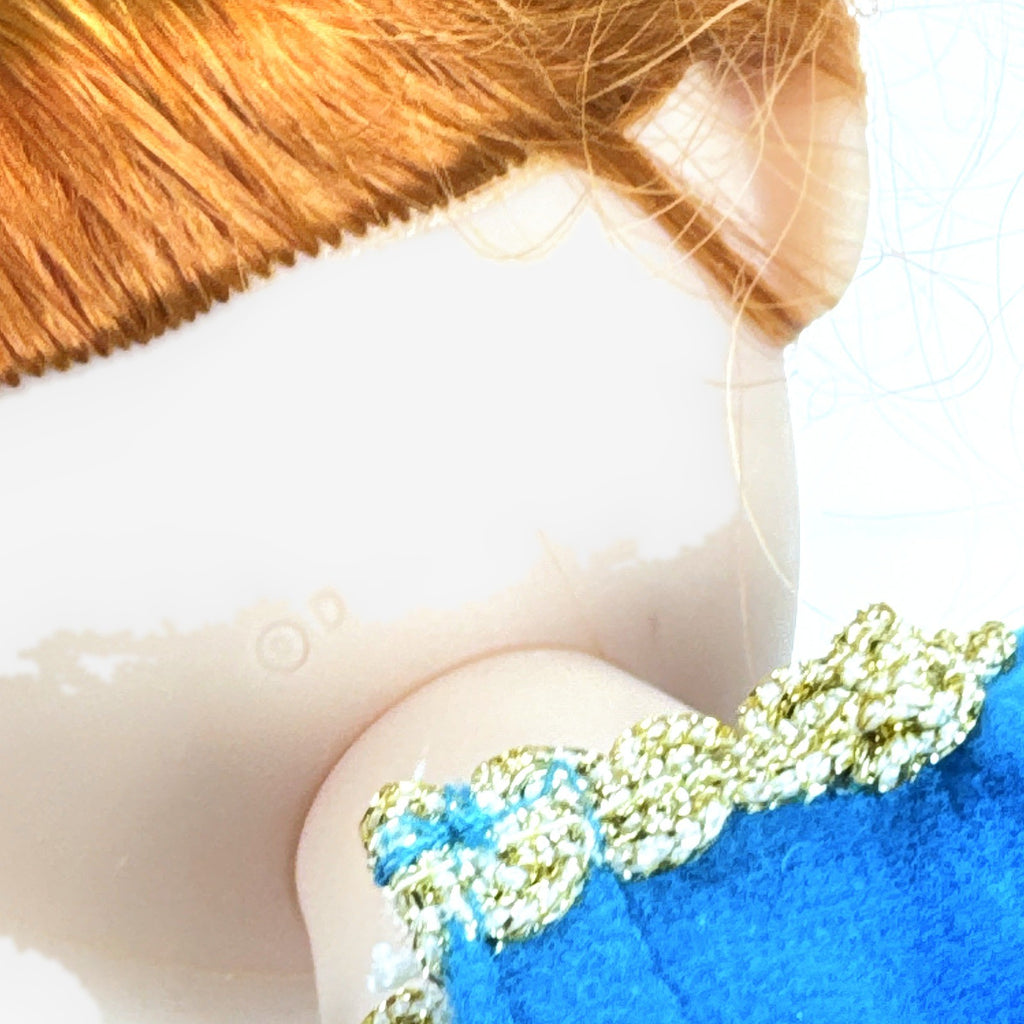 Disney Frozen 13-inch toddler Anna doll wearing blue dress and green pom-pom shoes
