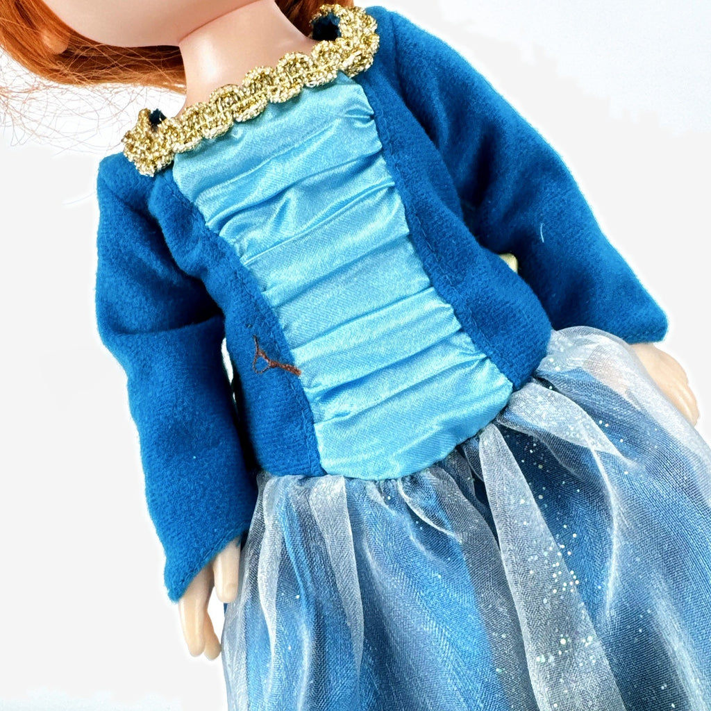 Disney Frozen 13-inch toddler Anna doll wearing blue dress and green pom-pom shoes