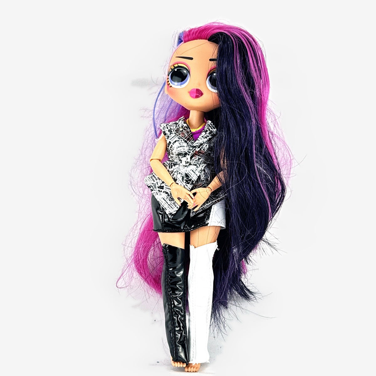 L.O.L. Surprise! OMG Movie Magic Ms. Direct fashion doll wearing newspaper comic print outfit and split-tone hair