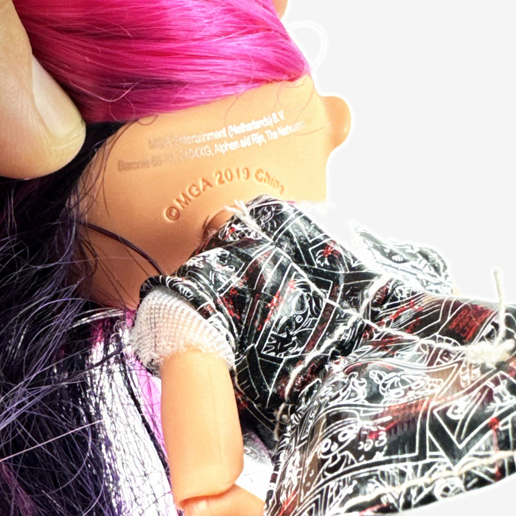 L.O.L. Surprise! OMG Movie Magic Ms. Direct fashion doll wearing newspaper comic print outfit and split-tone hair