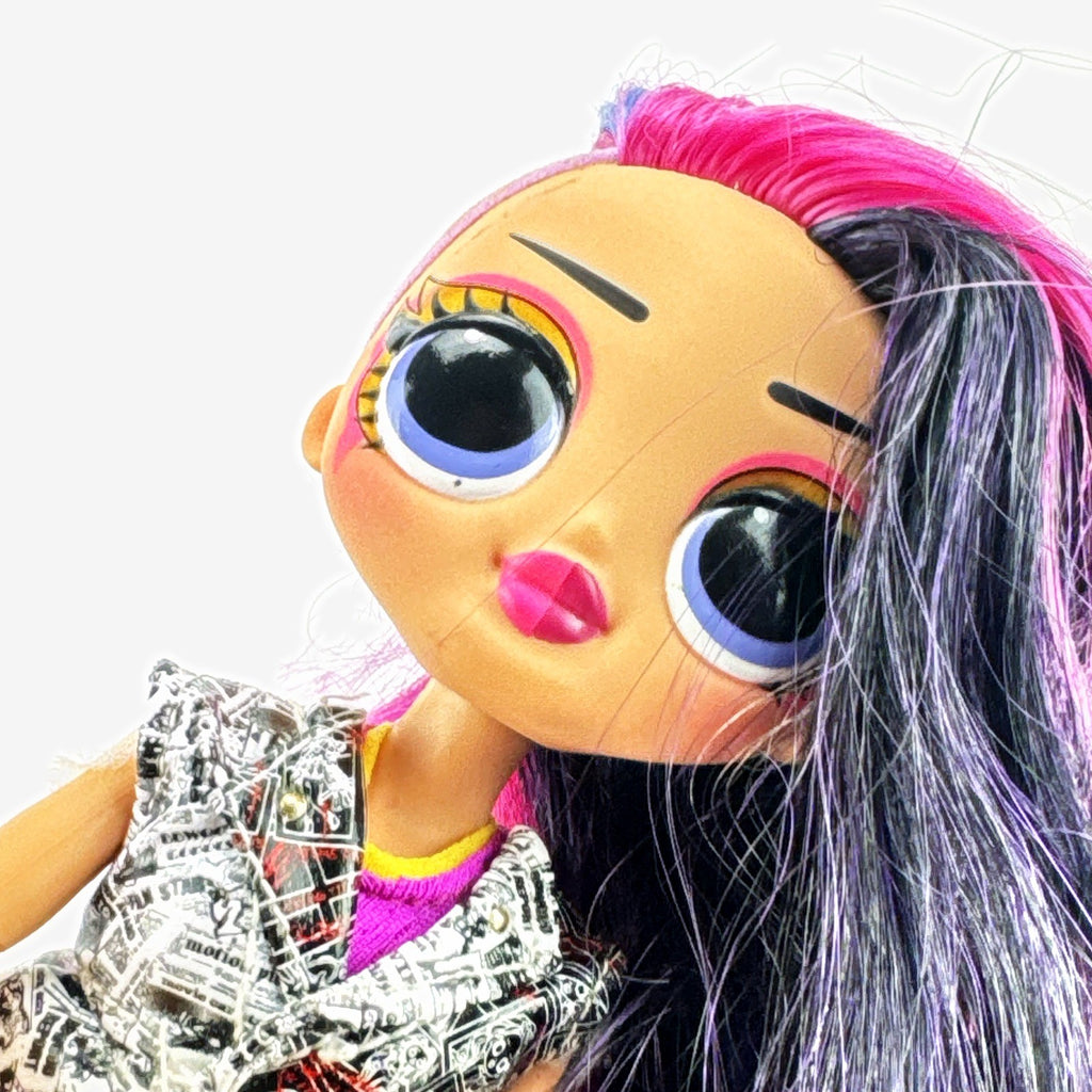 L.O.L. Surprise! OMG Movie Magic Ms. Direct fashion doll wearing newspaper comic print outfit and split-tone hair