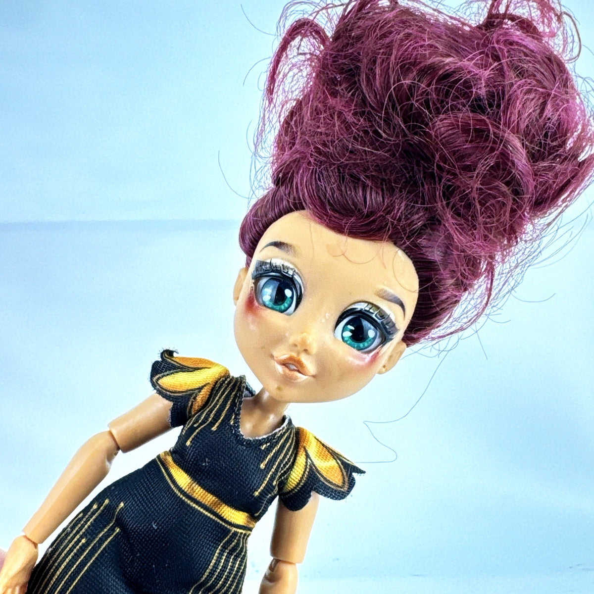Moose Toys FailFix Dance Stylz fashion doll wearing black and gold dress with burgundy updo
