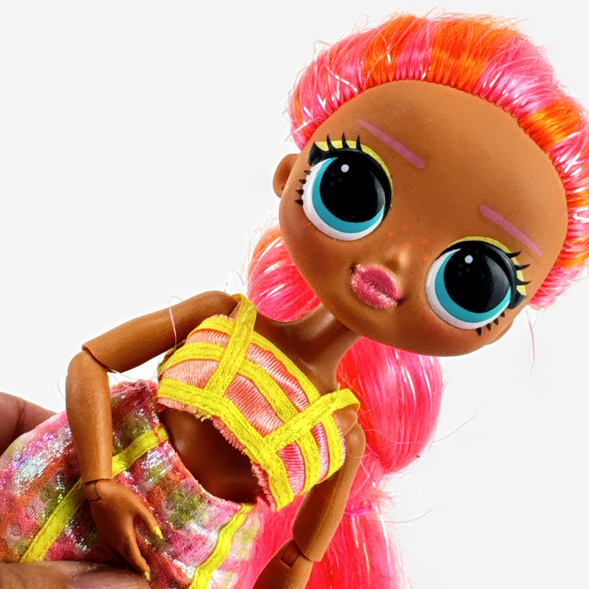 MGA L.O.L. Surprise! O.M.G. Lights Dazzle 10-inch doll in neon two-piece outfit with pink wedge boots