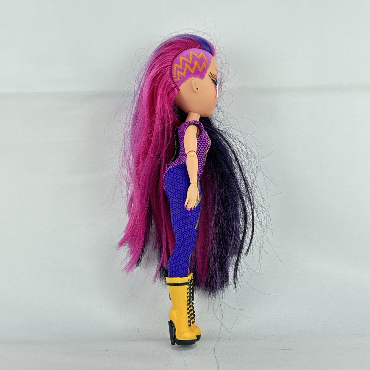 MGA L.O.L. Surprise! O.M.G. Remix Fame Queen 9-inch fashion doll wearing lightning bolt bodysuit and yellow platform boots