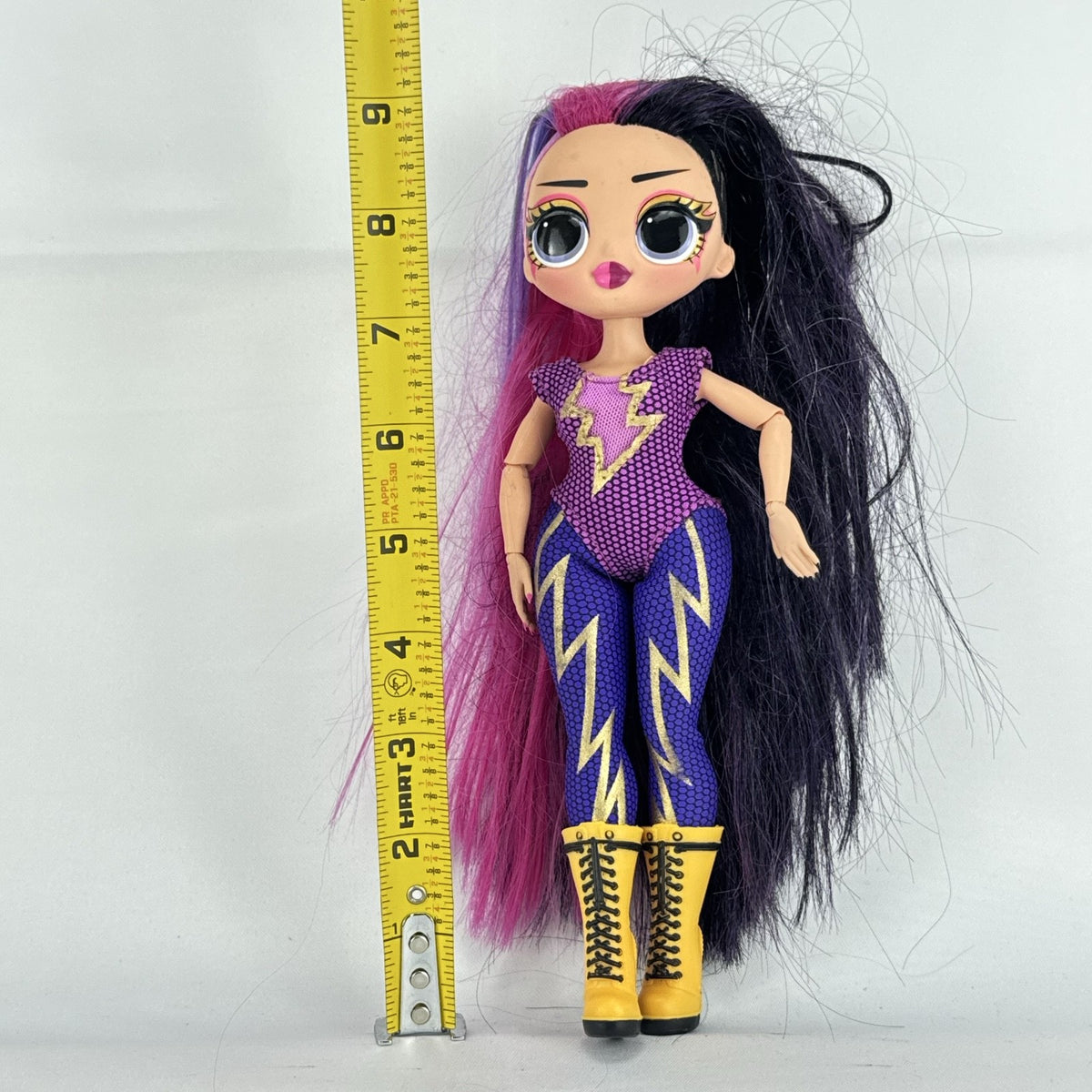 MGA L.O.L. Surprise! O.M.G. Remix Fame Queen 9-inch fashion doll wearing lightning bolt bodysuit and yellow platform boots