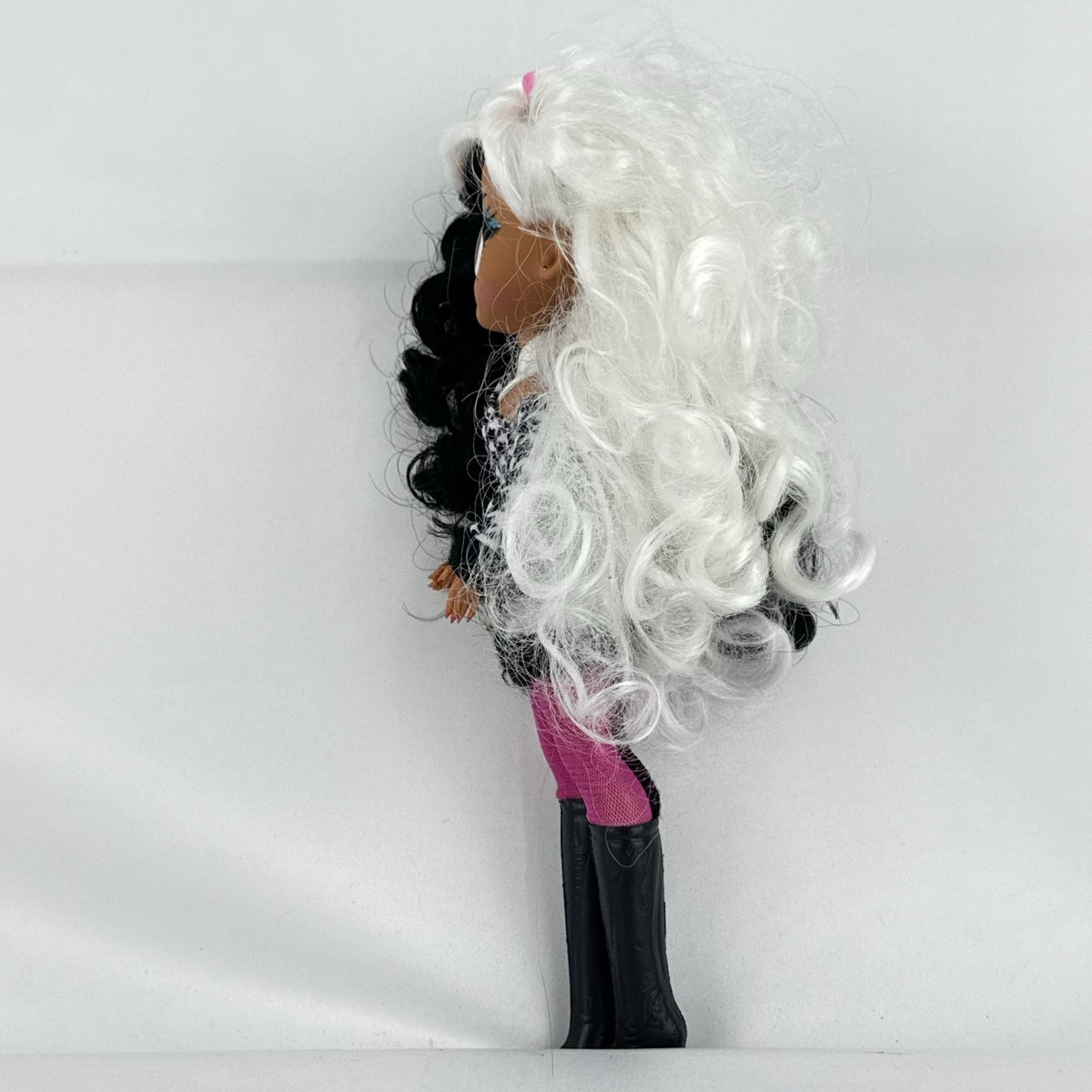 MGA L.O.L. Surprise O.M.G. Winter Disco Dollie fashion doll with split black and white curly hair and houndstooth dress