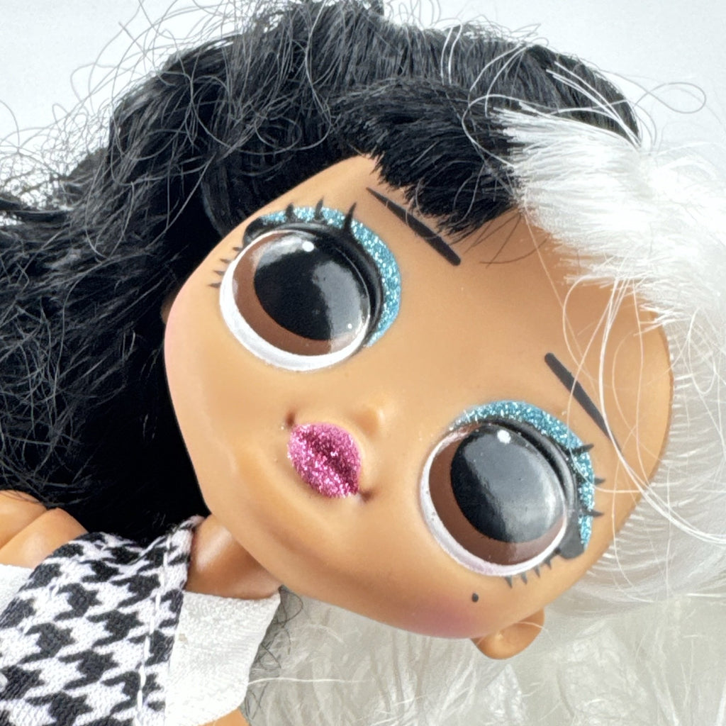 MGA L.O.L. Surprise O.M.G. Winter Disco Dollie fashion doll with split black and white curly hair and houndstooth dress