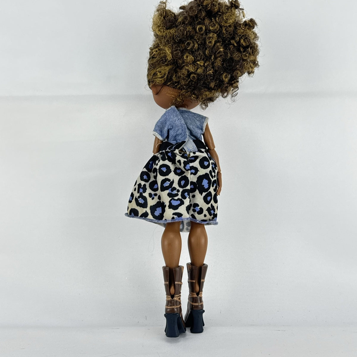 MGA L.O.L. Surprise! O.M.G. Royal Bee fashion doll with curly brown hair in an animal print outfit and lace-up boots