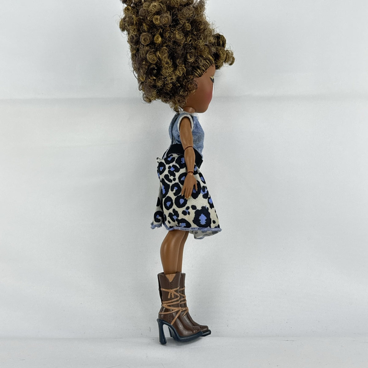 MGA L.O.L. Surprise! O.M.G. Royal Bee fashion doll with curly brown hair in an animal print outfit and lace-up boots