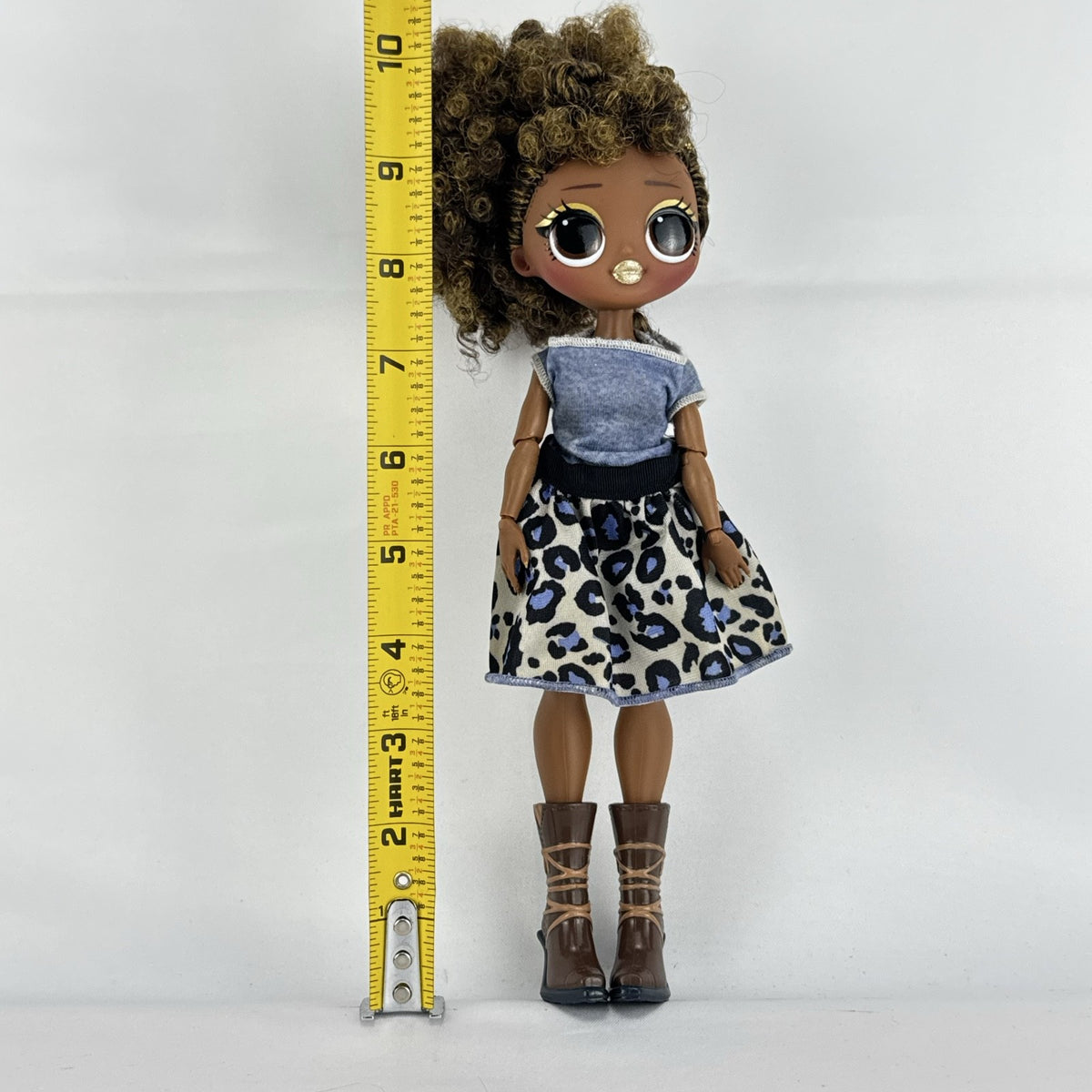 MGA L.O.L. Surprise! O.M.G. Royal Bee fashion doll with curly brown hair in an animal print outfit and lace-up boots