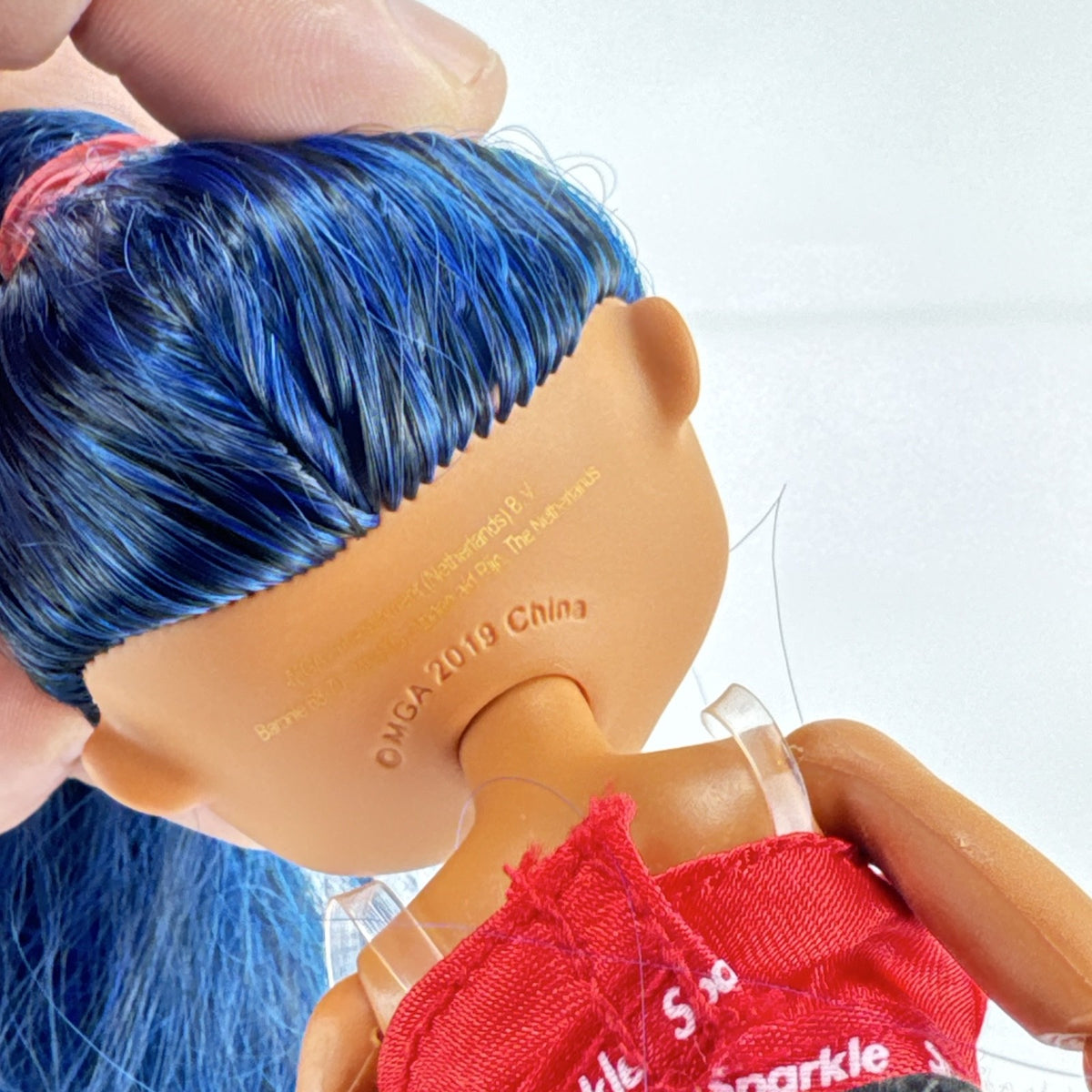 MGA L.O.L. Surprise! O.M.G. Downtown B.B. fashion doll with high blue ponytail and checkered shorts