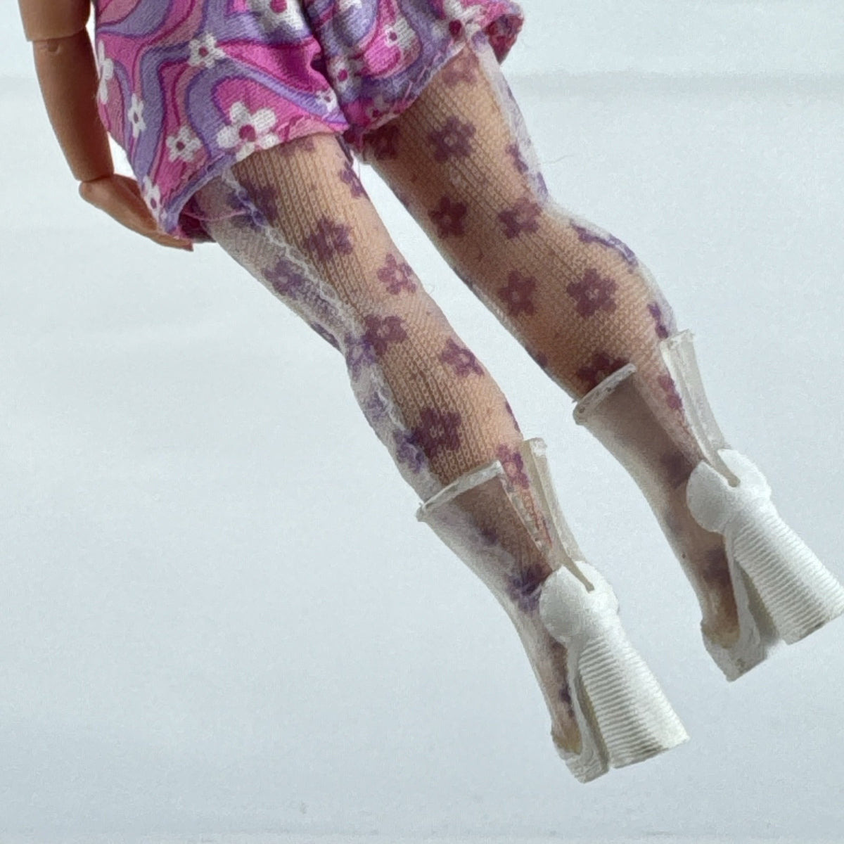MGA L.O.L. Surprise Tweens Series 2 Goldie Twist doll wearing floral outfit, tights, and clear boots