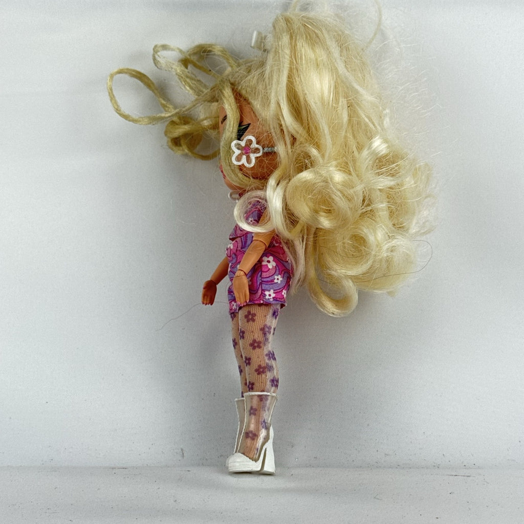 MGA L.O.L. Surprise Tweens Series 2 Goldie Twist doll wearing floral outfit, tights, and clear boots