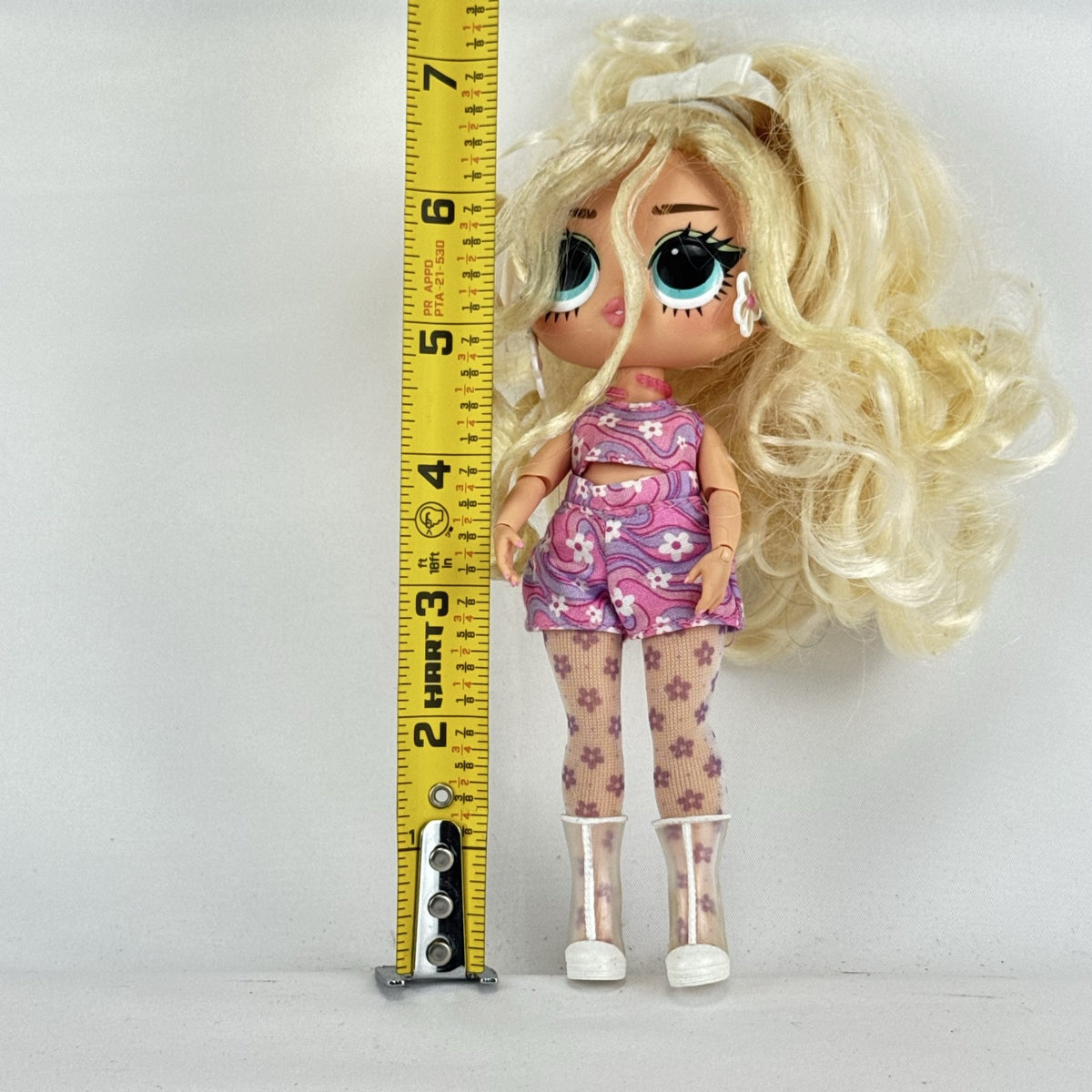 MGA L.O.L. Surprise Tweens Series 2 Goldie Twist doll wearing floral outfit, tights, and clear boots