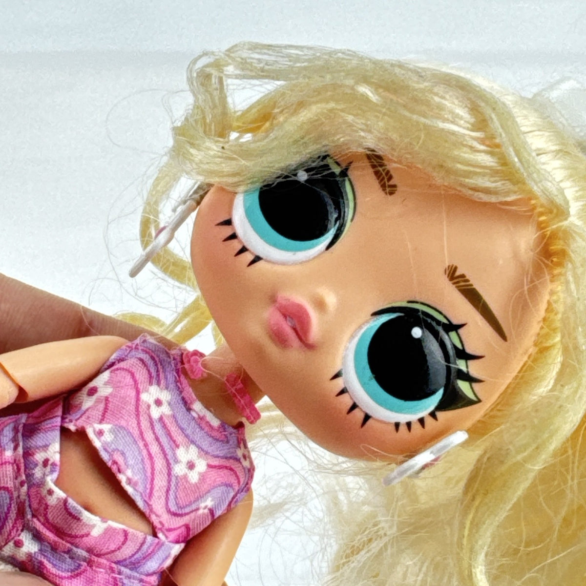 MGA L.O.L. Surprise Tweens Series 2 Goldie Twist doll wearing floral outfit, tights, and clear boots