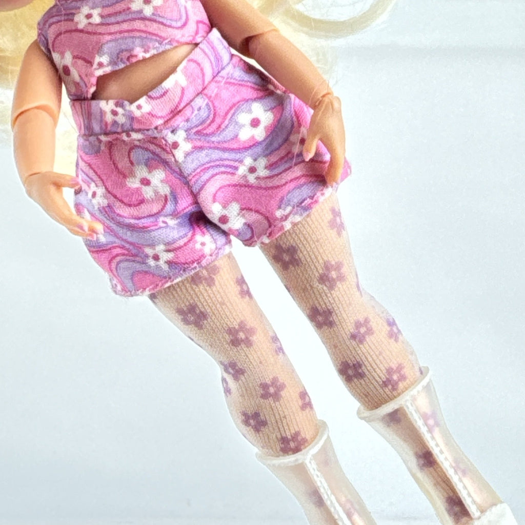 MGA L.O.L. Surprise Tweens Series 2 Goldie Twist doll wearing floral outfit, tights, and clear boots