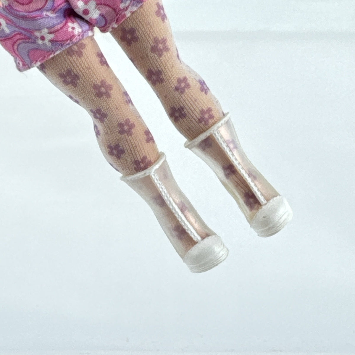 MGA L.O.L. Surprise Tweens Series 2 Goldie Twist doll wearing floral outfit, tights, and clear boots