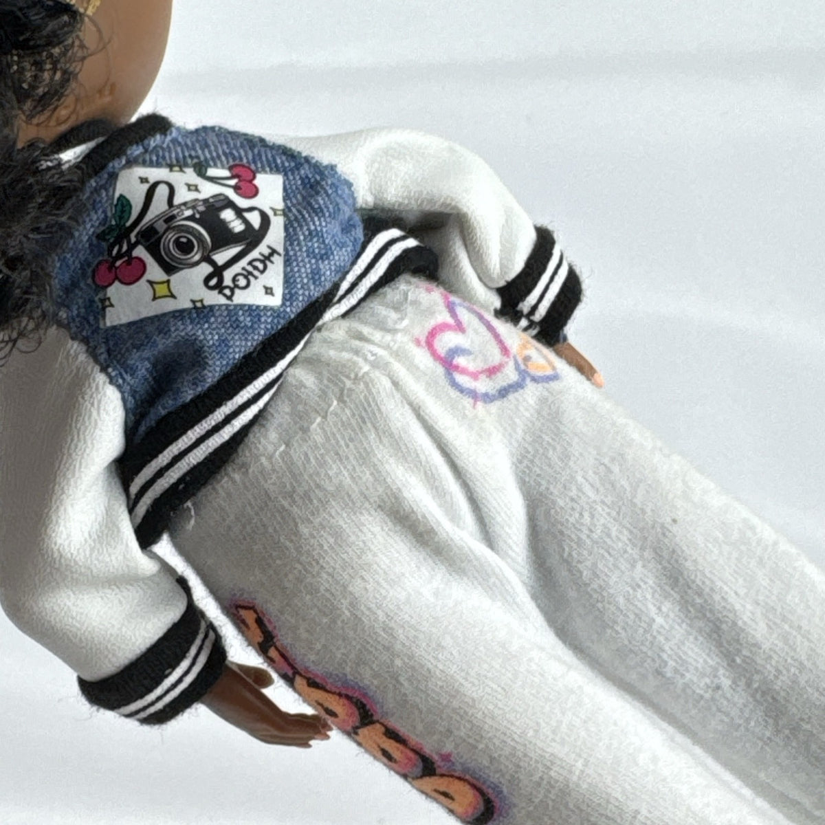 MGA Entertainment L.O.L. Surprise! Tweens Hoops Cutie fashion doll wearing varsity jacket and MVP athletic outfit