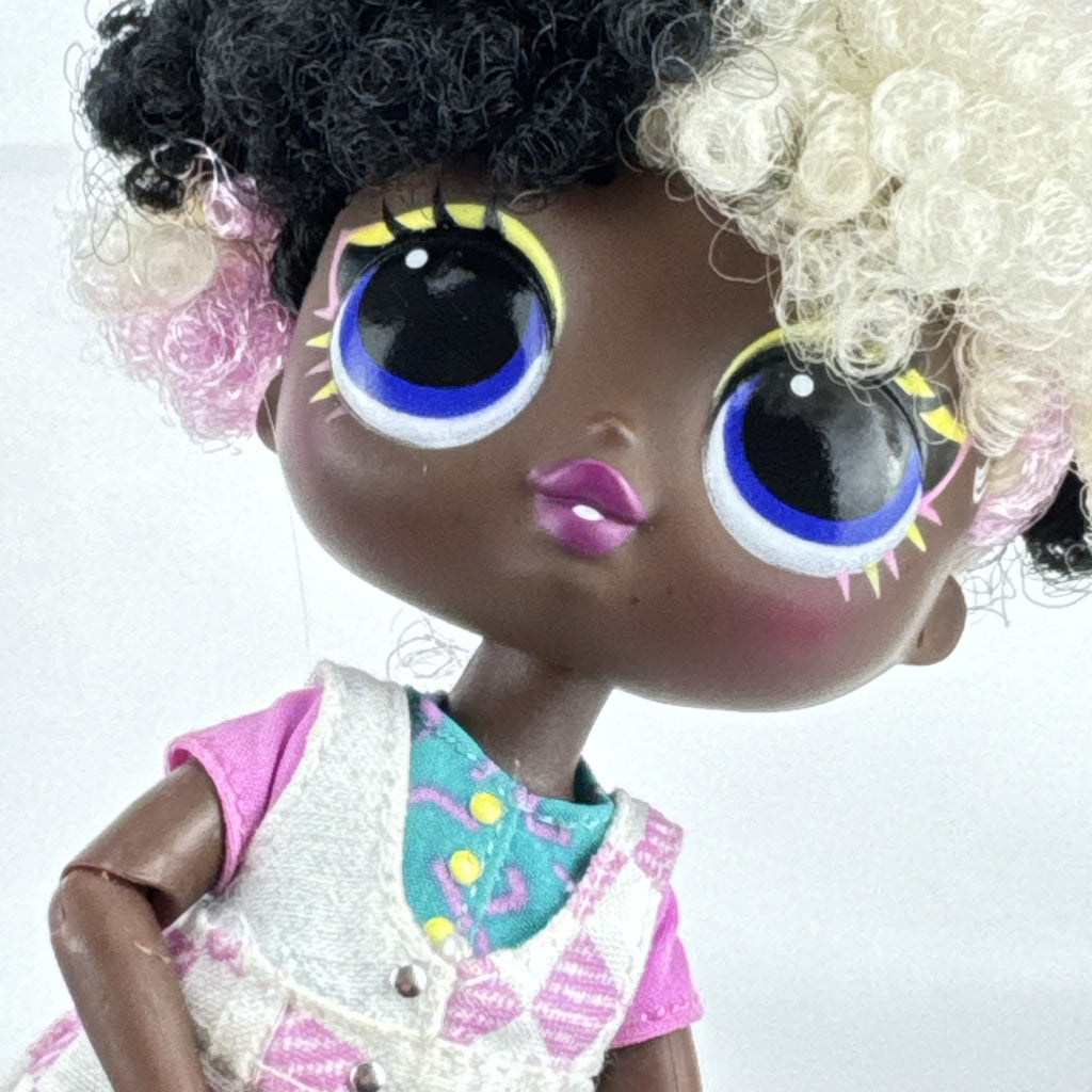 MGA LOL Surprise Tweens Winnie fashion doll in split checkered overalls with two-tone curly afro puff buns.