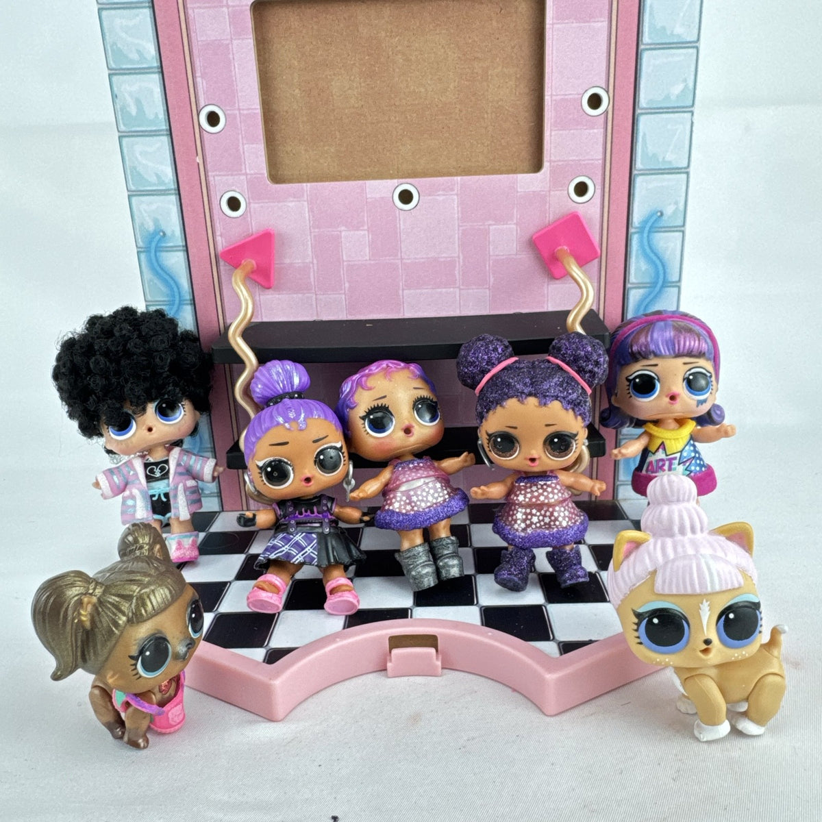MGA L.O.L. Surprise stage playset featuring a pink arched backdrop, checkered floor, five mini dolls, and two pets