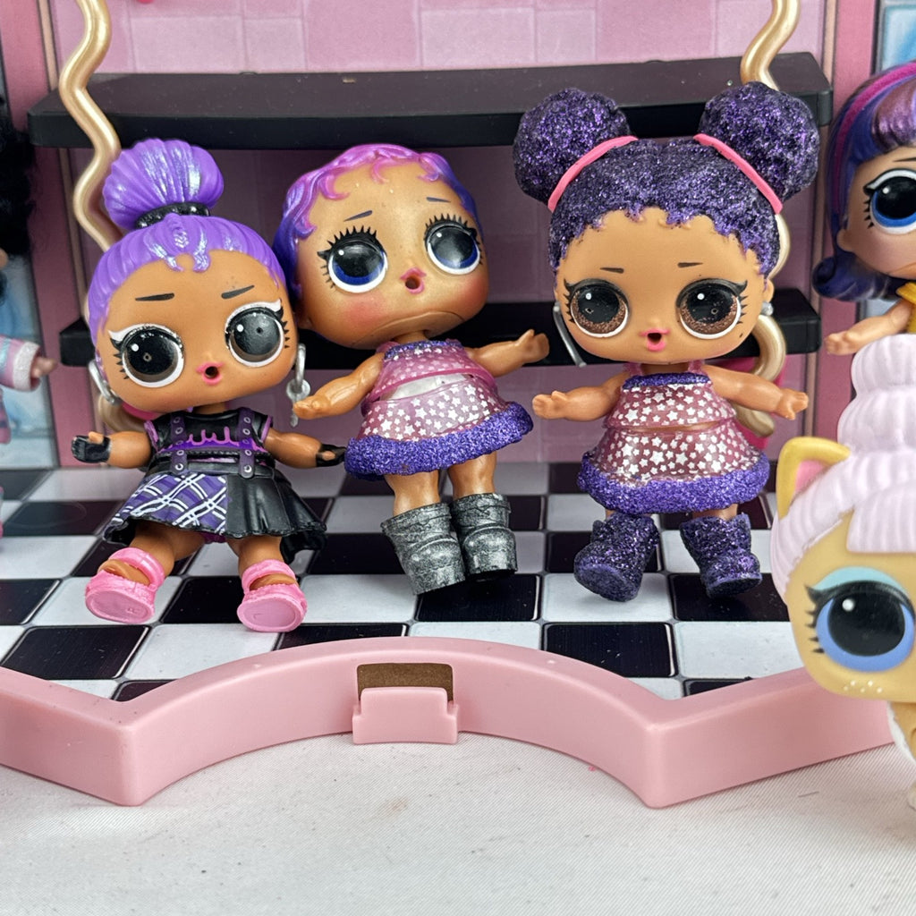 MGA L.O.L. Surprise stage playset featuring a pink arched backdrop, checkered floor, five mini dolls, and two pets