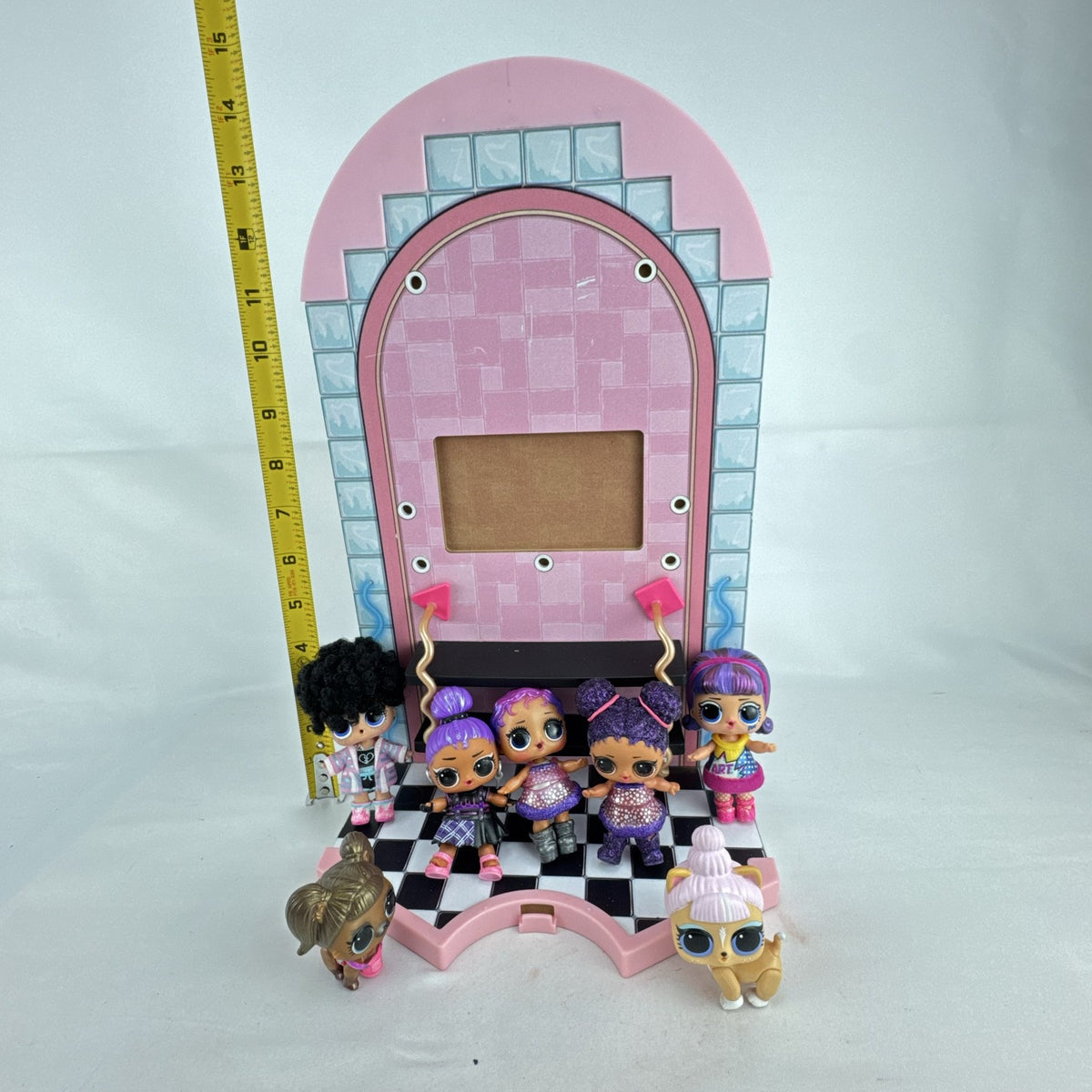 MGA L.O.L. Surprise stage playset featuring a pink arched backdrop, checkered floor, five mini dolls, and two pets