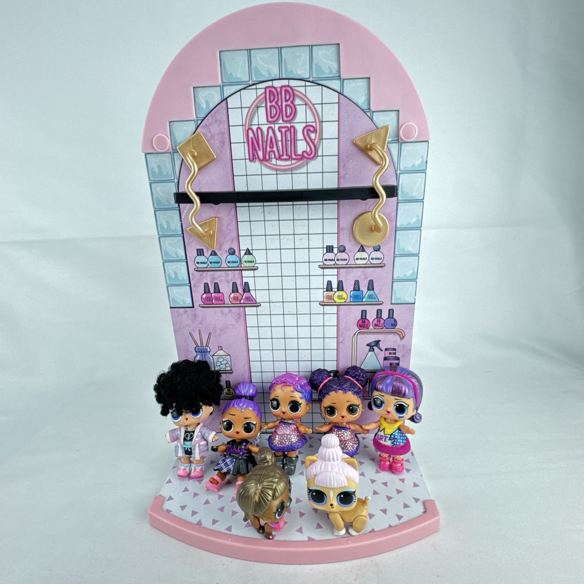 MGA L.O.L. Surprise stage playset featuring a pink arched backdrop, checkered floor, five mini dolls, and two pets