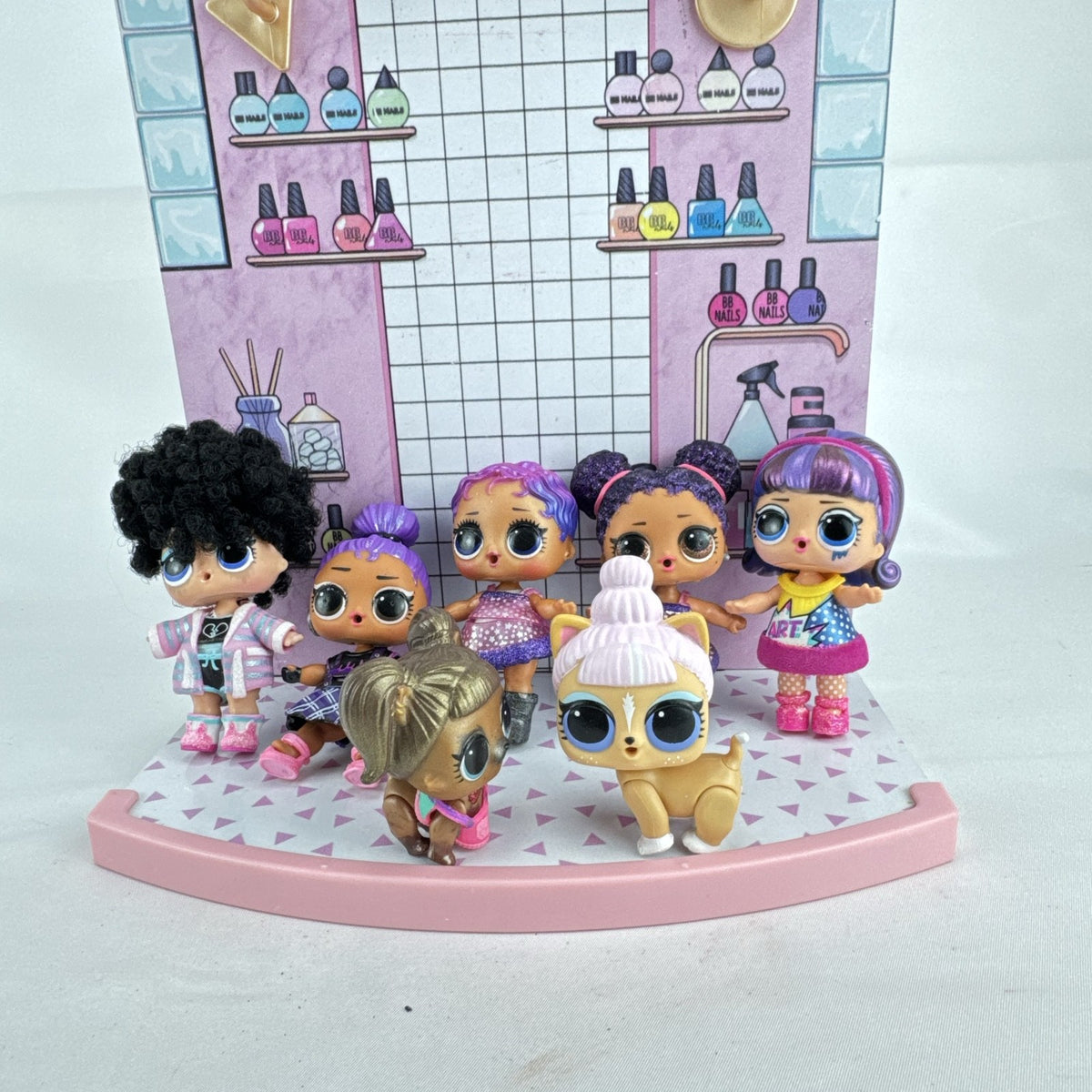 MGA L.O.L. Surprise stage playset featuring a pink arched backdrop, checkered floor, five mini dolls, and two pets