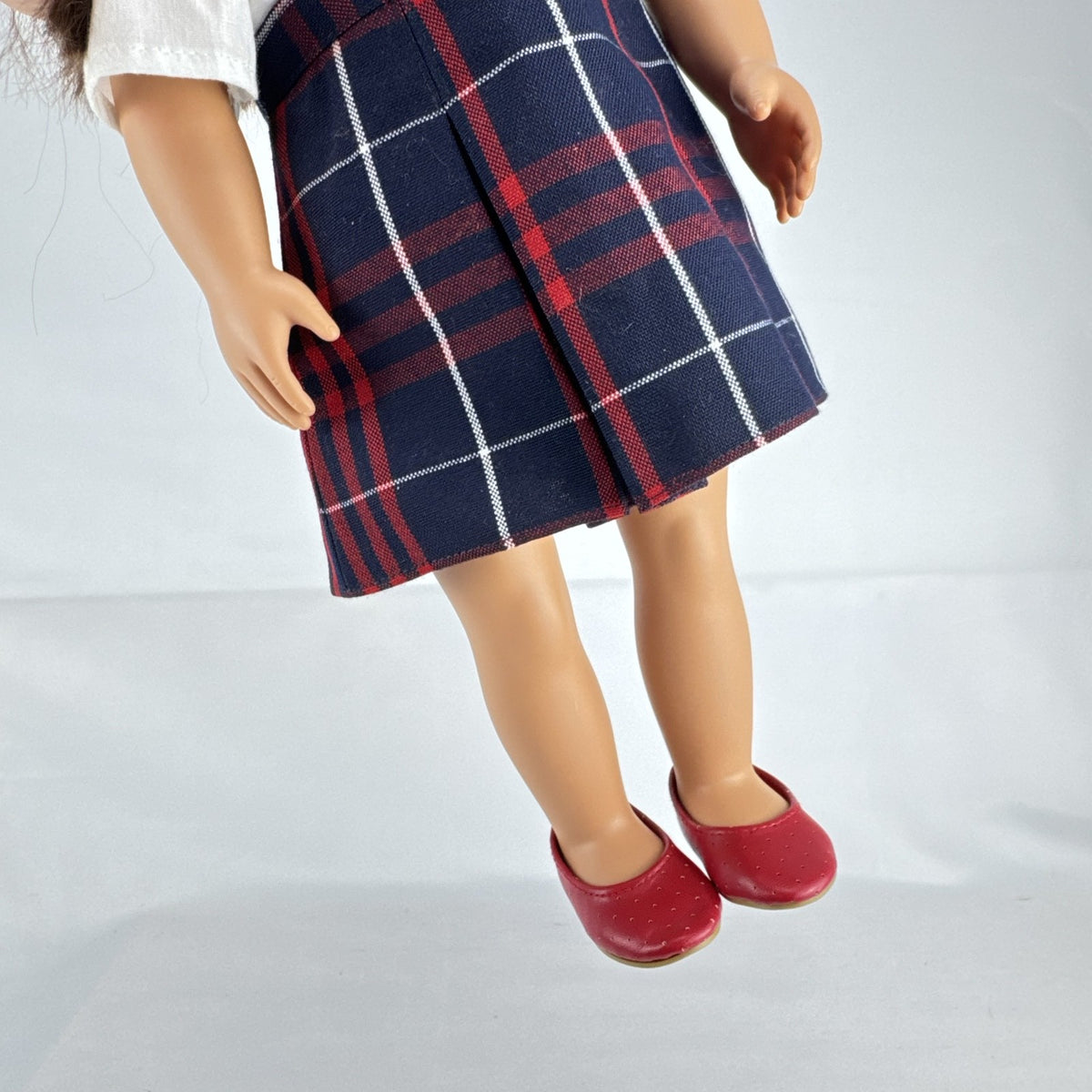 Battat Our Generation 18-inch doll with brown hair and eyes in red and navy plaid school uniform dress and red shoes